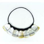 A necklace from the Philippines of rattan and engraved mother of pearl
