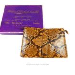 An original boxed, circa 1930's, snakeskin (python) clutch bag