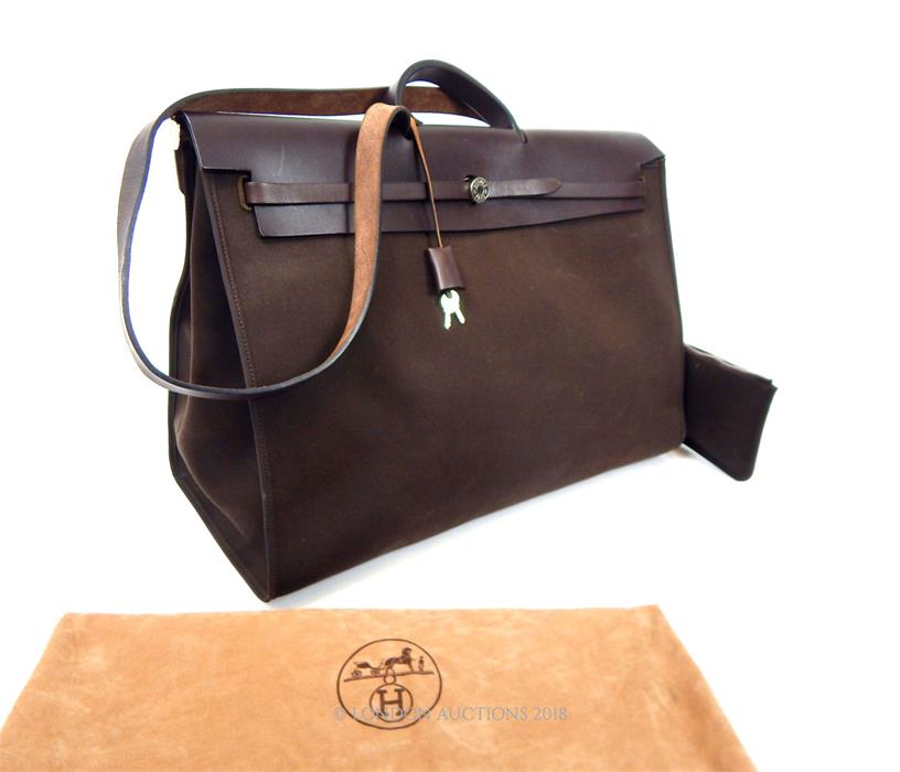 A Hermes, men's, large chocolate brown leather and fabric holdall