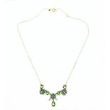 An antique, yellow gold, faceted peridot and seed pearl studded necklace