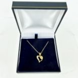 A boxed, 14 ct yellow gold heart-shaped and diamond pendant on chain