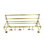 A brass luggage rack style coat hook