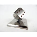 A Steel paper weight in the form of a dice.