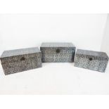 A set of three graduated Indian style metal trunks