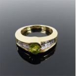 A boxed, 14 ct yellow gold, diamond and peridot ring