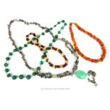 A collection of beaded necklaces to include amber and malachite examples