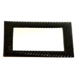 A carved, fluted wooden framed, rectangular mirror