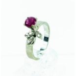 A boxed, 14 ct white gold, ruby and diamond ring