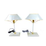 A pair of grey painted table lamps with matching shades