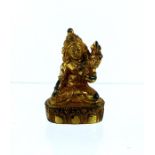 A miniature Oriental gilt metal seated Buddha figure,