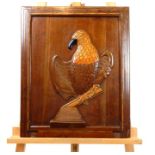 A carved eagle on a hardwood panel