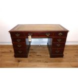 An Edwardian mahogany pedestal desk