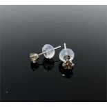 A boxed pair of platinum, diamond stud earrings (0.30 carats total)