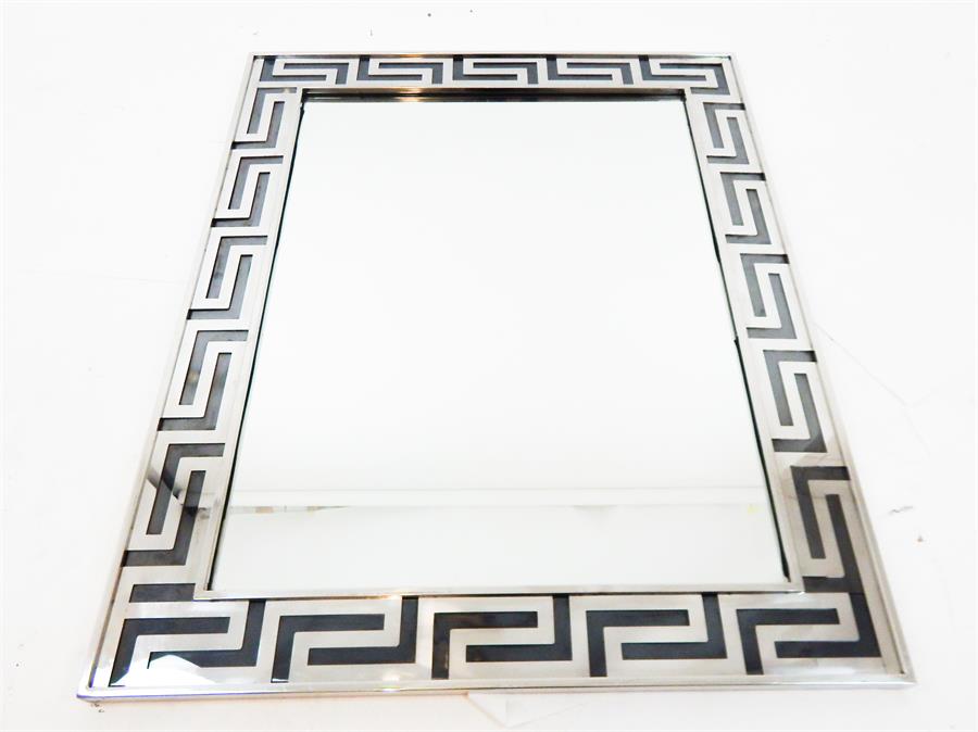 A chromed rectangular wall mirror
