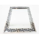 A chromed rectangular wall mirror