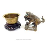 A Chinese bronze mythical beast with a bronze censer
