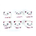 A set of six cat head string holders