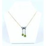 An antique, yellow gold, diamond, peridot and seed pearl, bow necklace