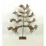 A large, silvered-metal, candle holder in the form of a tree