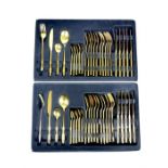 Two boxes of gilt steel flatware