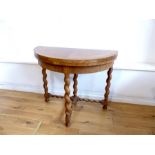 An early 20th century, walnut, circular table on barley-twist legs