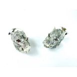 A pair of 800 silver condiments in the form of Boars heads with Ruby eyes