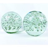 Pair of large, clear-glass paperweights