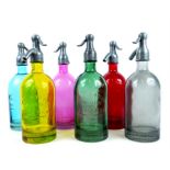 A set of six coloured glass models of soda siphons