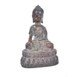 A bronzed Tibetan seated Buddha figure