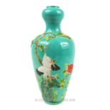 A Chinese vase with a turquoise ground and storks in relief