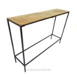 A contemporary console table with a bronzed top