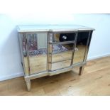 A contemporary mirrored chest of drawers