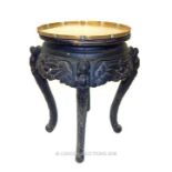 An oriental, ebonised, occasional table with an engraved brass tray top