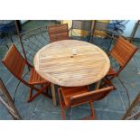 A teak, slatted circular garden table and four matching chairs