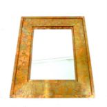 A decorative, copper-framed mirror