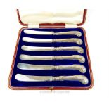 A red-leather cased, set of six sterling silver butter knives