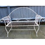 A white painted metal folding garden bench
