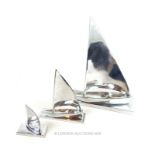 A graduated set of three Art Deco style chromed sculptures of sailing ships