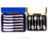 Cased 6 silver teaspoons and 6 cased silver handled butter knives .