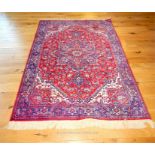 A Persian style machine made rug