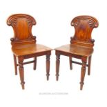 A pair of Victorian mahogany hall chairs