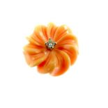 An 18 ct yellow gold, carved coral and diamond, flower pendant