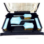 A cased sterling silver and sky blue enamel dressing set