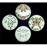 A collection of four Chinese carved jade discs