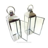 A pair of chromed storm lanterns