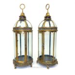 A pair of antique-style, gilt metal storm lanterns