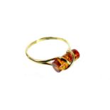 A 9 ct yellow gold natural amber ring