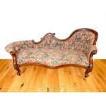 An antique, hand-carved mahogany and upholstered chaise