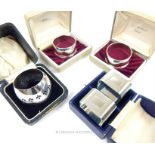 Five sterling silver napkin rings in four boxes
