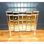 A contemporary double break front mirrored chest